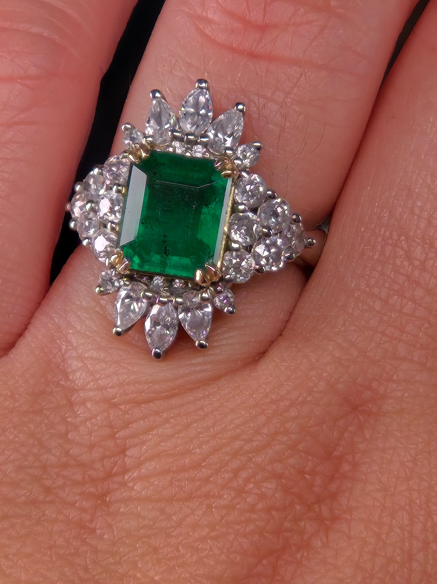Emerald City Skyline emerald and diamond ring worn on a hand, displaying the ring's size and elegant design.