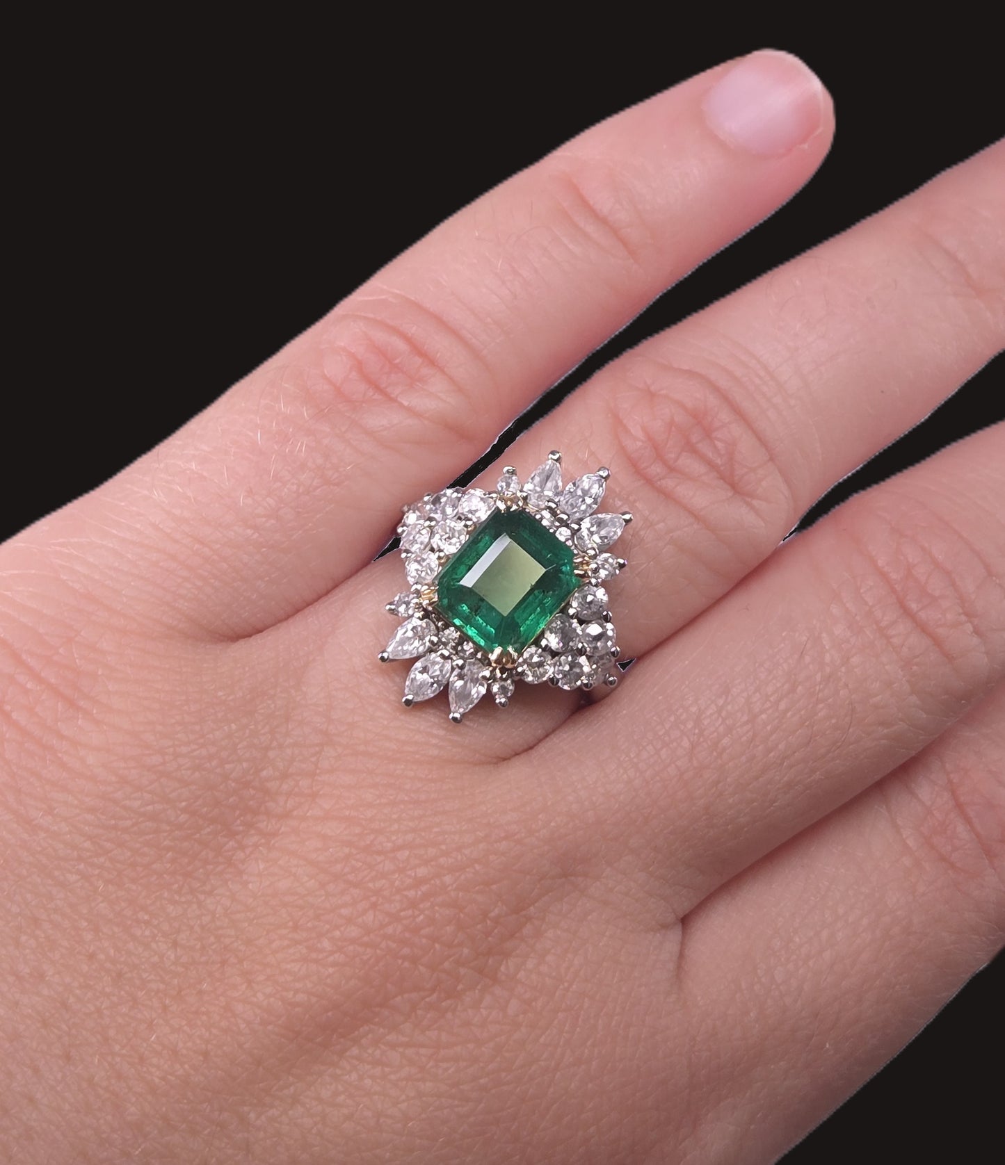 Emerald City Skyline emerald and diamond ring worn on a hand, displaying the ring's size and elegant design.