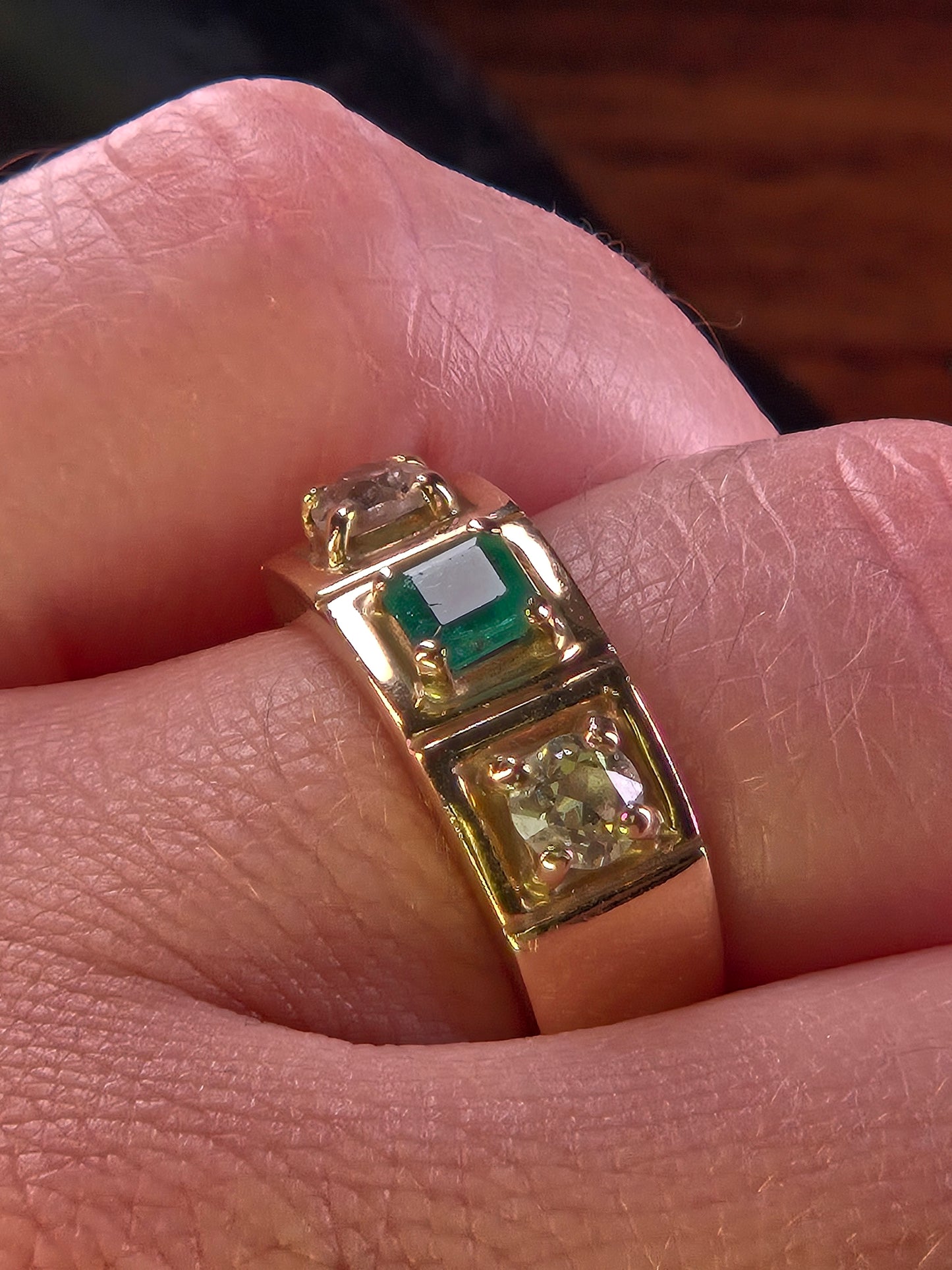 Side profile of The Empress ring on a hand, showcasing the substantial 18K yellow gold band and setting height.