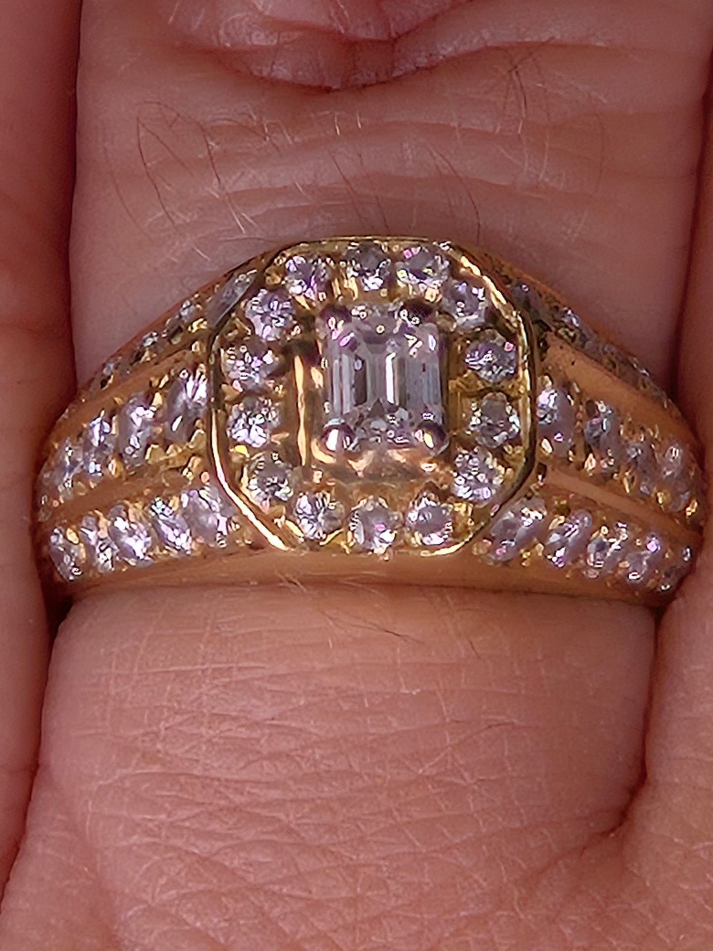 Macro detail shot of The Golden Age ring, focusing on the VS-SI clarity of the emerald-cut center diamond and surrounding halo.