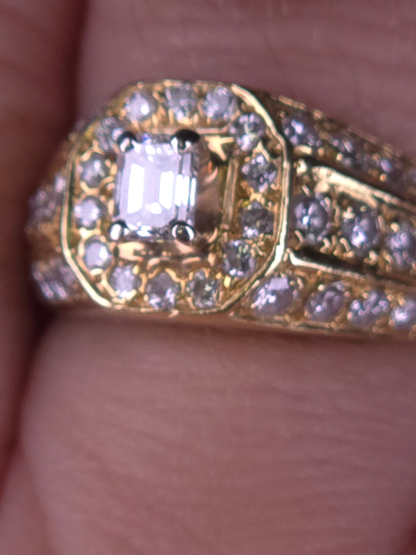 Macro detail shot of The Golden Age ring, focusing on the VS-SI clarity of the emerald-cut center diamond and surrounding halo.