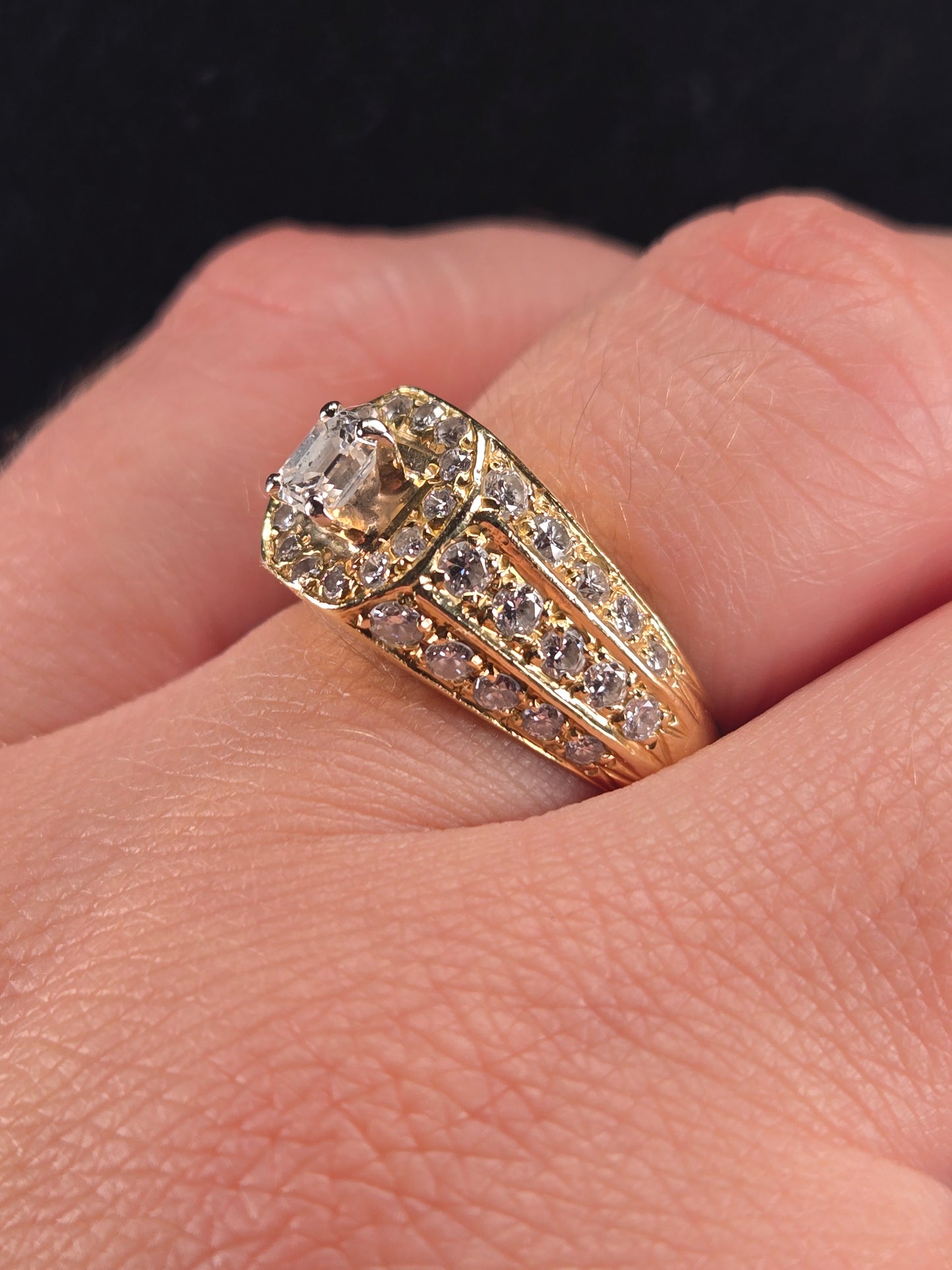 A model wearing The Golden Age vintage-style diamond ring, with a focus on how the ring sits on the finger.
