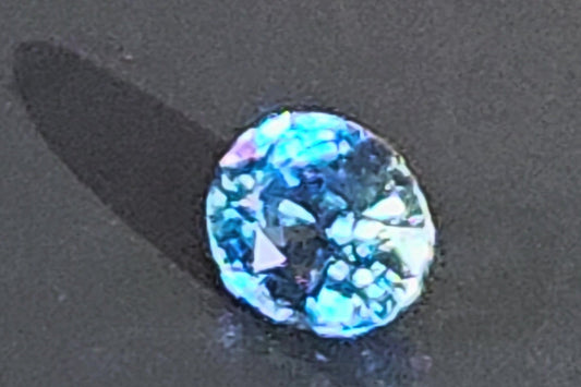 Blue gemstone on a dark background