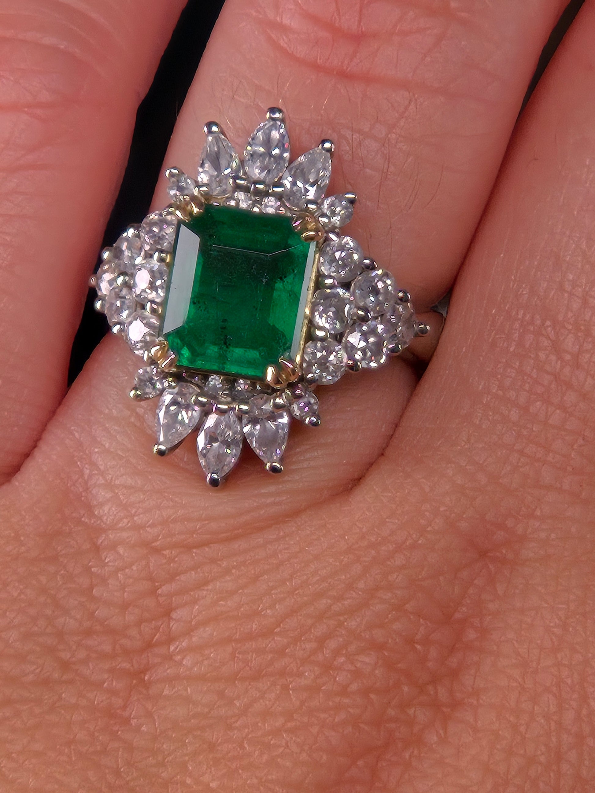 Emerald City Skyline emerald and diamond ring worn on a hand, displaying the ring's size and elegant design.