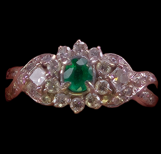 Studio photograph of the Jardin Japonais ring, showing a 0.25ct Colombian emerald surrounded by diamonds in a floral platinum setting.