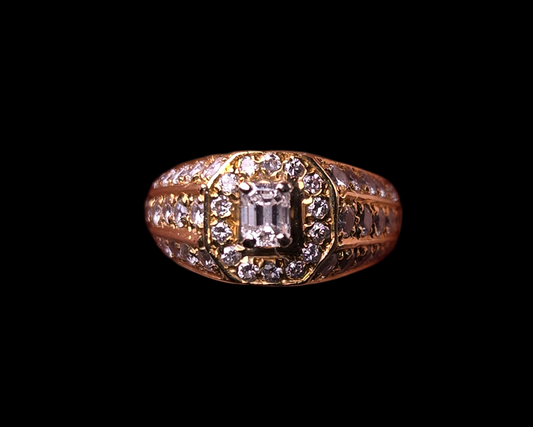 Top-down studio shot of The Golden Age, a vintage-style emerald-cut diamond ring with a halo, set in 18K yellow gold.