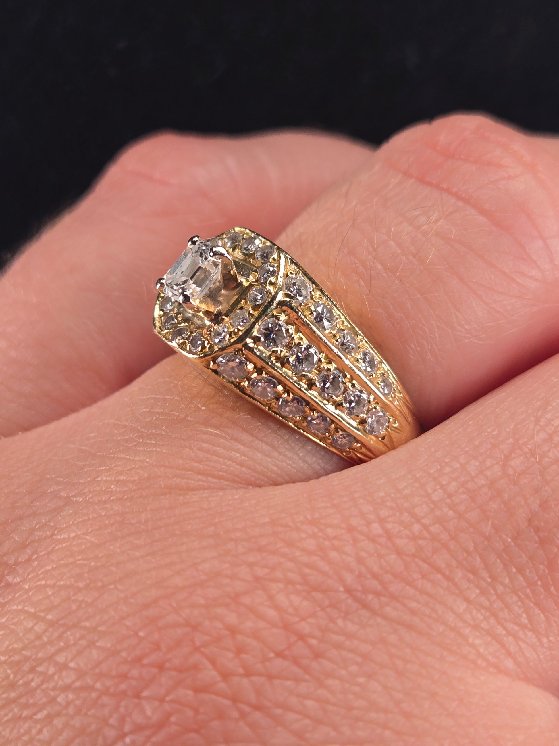 A model wearing The Golden Age vintage-style diamond ring, with a focus on how the ring sits on the finger.
